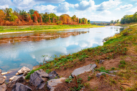 urban landscape with city park and a river in front. beautiful autumn scenery of Uzhhorod Orthodox embankment. vacation background with sky reflection on the water. fall season in Urkaine