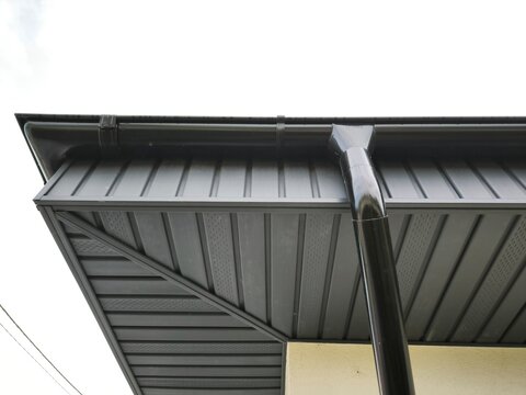 Metal soffits and a downpipe on the building's facade