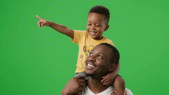 A young boy rides on his father's shoulders, pointing forward with a smile, embodying curiosity and exploration. on a green screen background