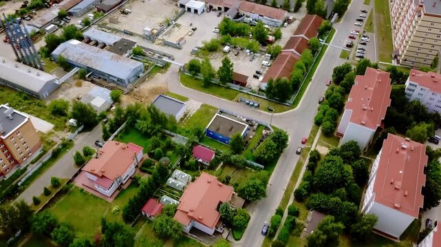 Aerial view of urban district with residential apartment buildings and industrial factories