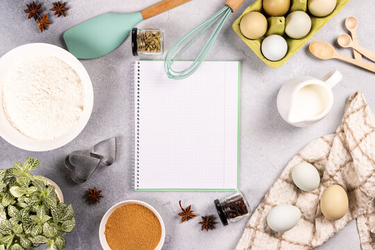 Baking ingredients with blank notebook for recipe