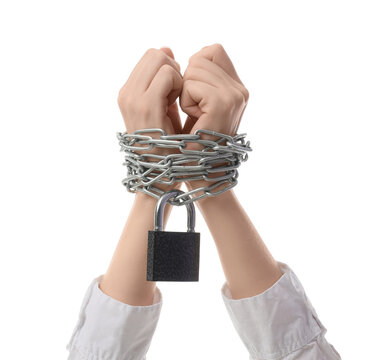 Oppression and lack of freedom, hands bound with metal chains and a padlock human rights violation and restriction of personal liberty