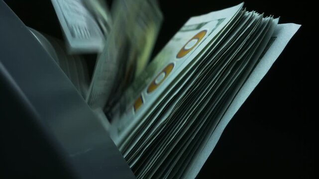 close up Money dollar counter. Money counting machine processing stacks of cash with visible hundred dollar bills in a close up view, showcasing the device's functionality and design features. 