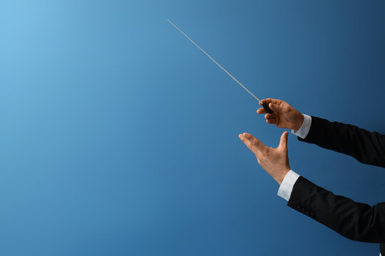 Male conductors hands on blue background