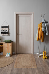 Interior of hallway with shoe stand, door and clothes rack