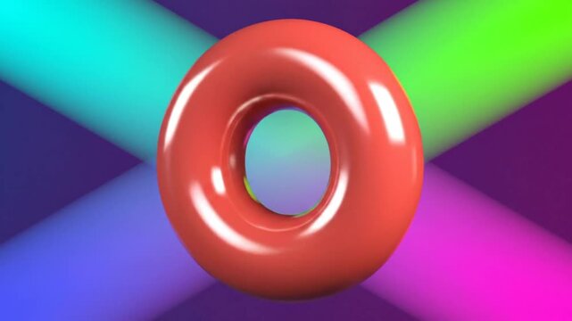 Glossy, red, toroidal shape rotating in front of a colorful, bright background with intersecting light beams