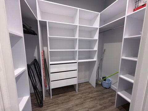 Modern Walk In Closet Interior with White Shelves and Storage System