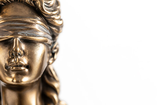 Bronze statue of lady justice with blindfold close up on face and hair