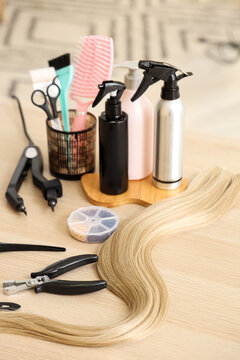 Hair extension tools on table in beauty salon, closeup