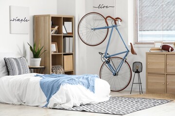 Minimalist interior design and urban lifestyle, modern bedroom with bicycle wall mount and...