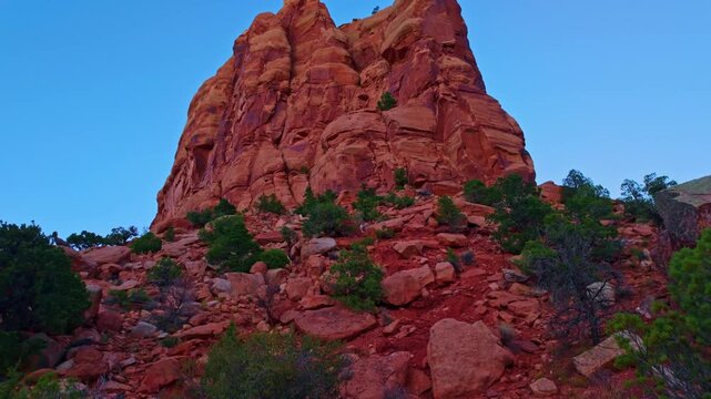 Vast canyon vista showcases colossal red sandstone monoliths rising dramatically along Monument Canyon Loop Trail in western Colorado
