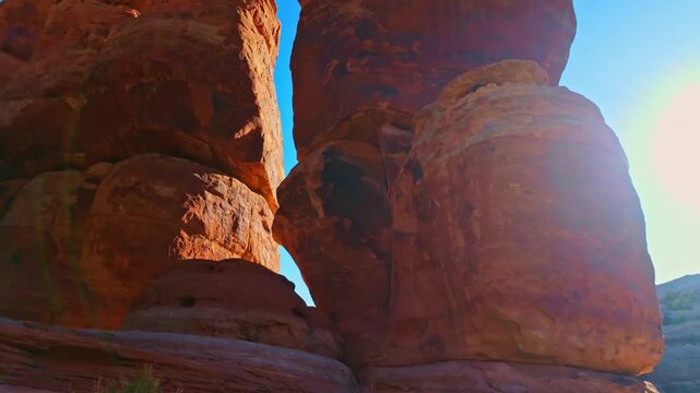 Warm morning sunrise light illuminates intricate textures on massive weathered sandstone spires along Devils Kitchen Trail in Colorado