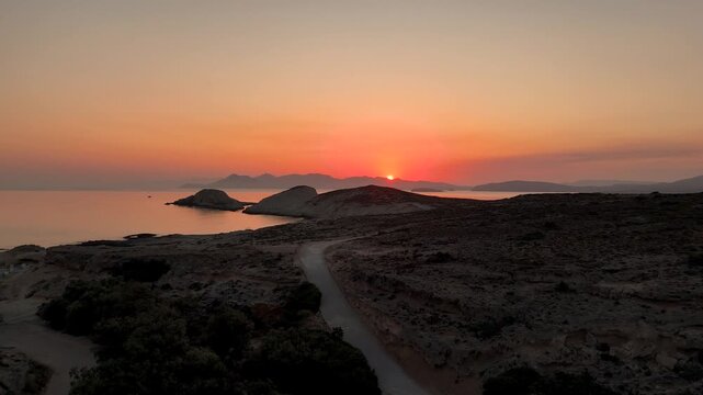 Beautiful orange and red sky in the early morning before sunrise on the Greek island Milos in Greece. 