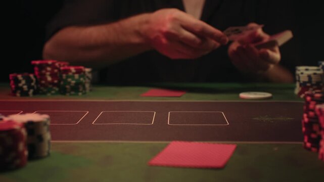 Casino player, Game of poker in casino, taking place with poker chips and cards on a green table betting chips, gambling place, roulette jack pot. All in bet game. 