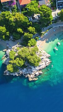 Vertical aerial view of Punta Rata beach and turquoise sea in Brela Croatia