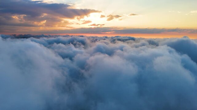 Aerial drone video of fluffy sea of clouds during breathtaking sunset in Sinop, Black Sea region, Turkey. Stunning cinematic landscape with bright sun rays shining through colorful dramatic sky cloud
