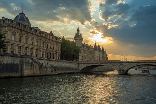 Conciergerie and Pont au Change over Seine River at sunset in Paris