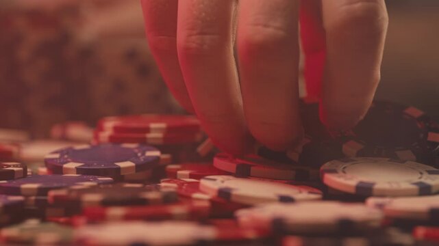 Casino player, Game of poker in casino, taking place with poker chips and cards on a green table betting chips, gambling place, roulette jack pot. All in bet game. 