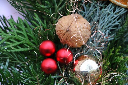 Close-up of Christmas decorations on a fir branch.