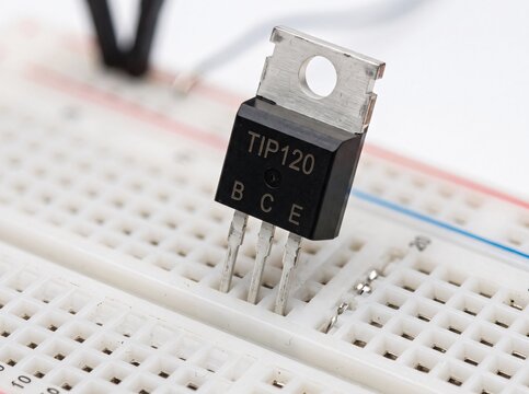 TIP120 darlington transistor inserted into a white breadboard for prototyping circuits.