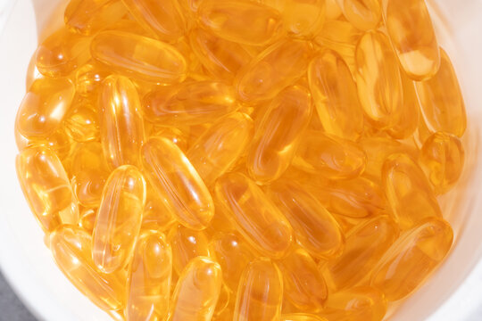 Omega 3 yellow gel capsules, vitamin d bg