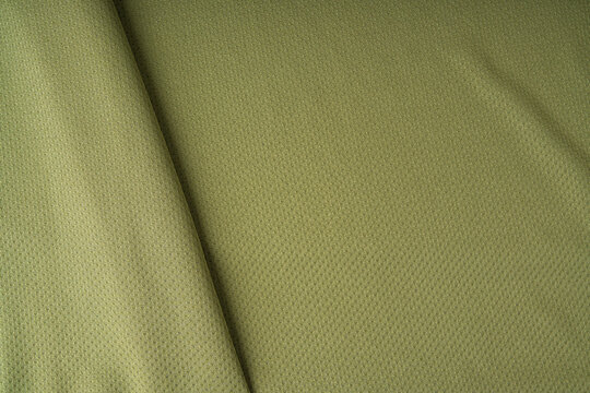 Sport cloth fabric texture background, olive green soccer shirt pattern