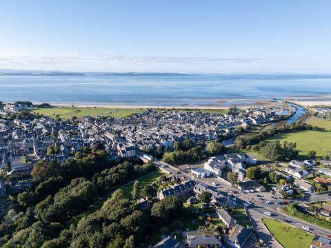 High wide aerial view of Nairn town center, River Nairn, Nairn Beach, and Moray Firth in Nairnshire, Scottish Highlands, Scotland