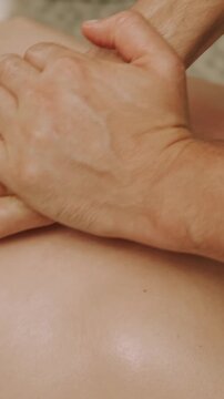 two hands press palms and fingers onto bare torso in closeup, emphasizing warm tactile contact and care