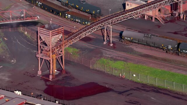 Aerial view of an iron ore processing plant with a freight train