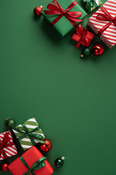 Christmas presents and ornaments on vertical green background with ribbons for Merry Christmas and Happy New Year