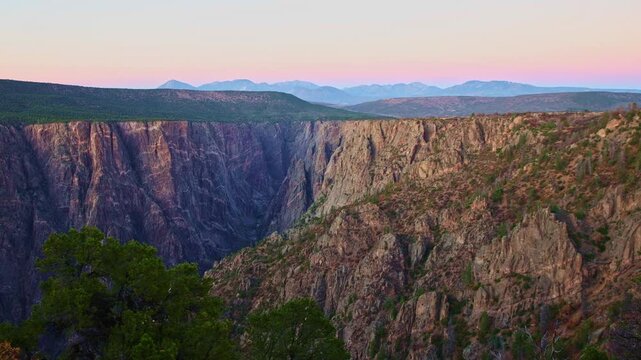 Subtle twilight colors illuminate the iconic marbled pegmatite veins of Painted Wall viewed from Warner Point in Black Canyon