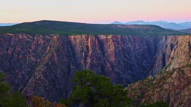 Subtle twilight colors illuminate the iconic marbled pegmatite veins of Painted Wall viewed from Warner Point in Black Canyon