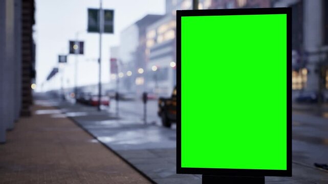 Vertical green screen citylight sign on a city sidewalk under high midday light, wet streets after rain. Time lapse of city traffic, bokeh lights and moving cars. Clean chroma key area for compositing