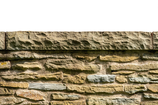 isolated old stone wall masonry with capstone