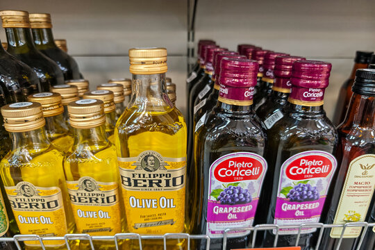 500 ml bottle of Filippo Berio Olive Oil with a golden label, alongside bottles of the same brand&rsquo;s Extra Virgin olive oil and Pietro Coricelli grape seed oil: Abakan, Russia - August 27, 2026