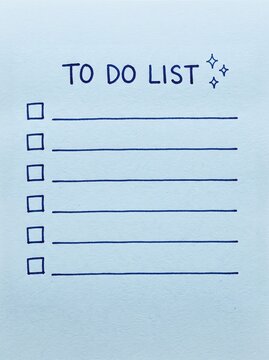 Blank to do list on a light blue sticky note with hand drawn checkboxes