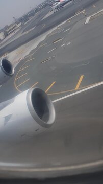 Footage filmed from inside a Mahan Air Airbus A340 during takeoff at Dubai International Airport. The forward view shows the runway and airport grounds as other aircraft gradually become smaller in th