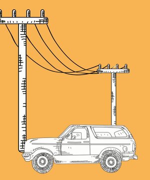 Classic off-road SUV vehicle under power utility poles