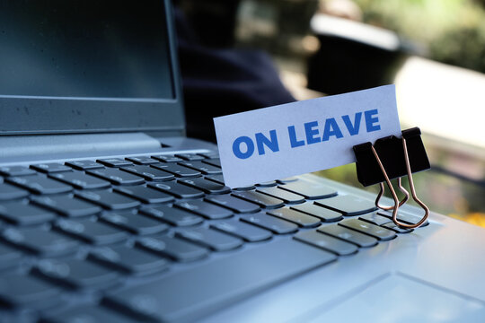 On Leave, annual leave for employees. An "ON LEAVE" sign with a paperclip resting on a keyboard. A break from work. Vacation, family event.
