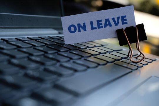 On Leave, annual leave for employees. An "ON LEAVE" sign with a paperclip resting on a keyboard. A break from work. Vacation, family event.