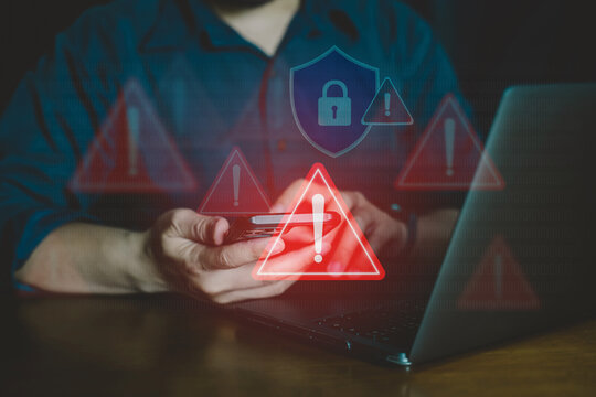 Man holding smartphone with cyber security warning and red exclamation mark icon