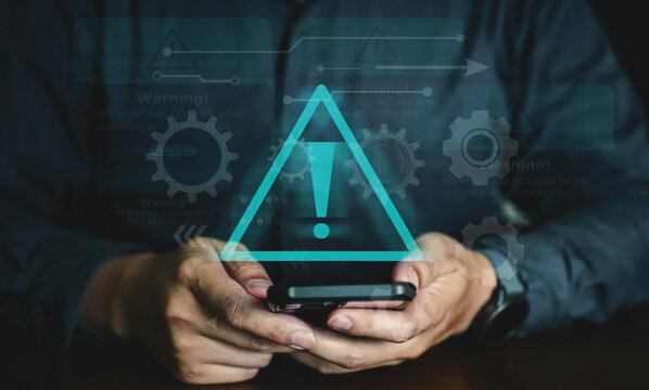 Person holding smartphone with red shield lock icon and warning exclamation mark for data security alert