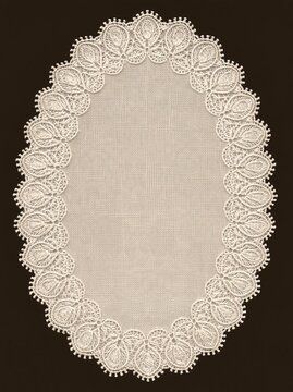 Oval lace doily with floral scalloped border on dark background