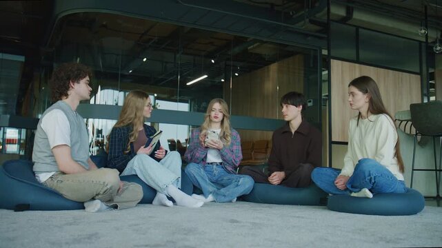 Psychology session with a group of young adults discussing thoughts and feelings. The psychologist gives each participant a toy so they can talk about their feelings.