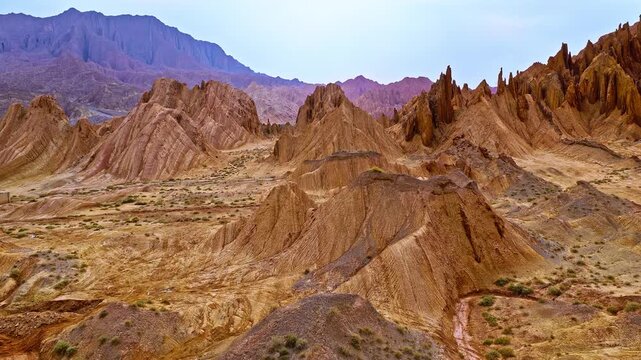 Aerial view of red sandstone canyon and eroded arid rock formations in the Red Mountain Stone Forest, Kuqa, Xinjiang, China