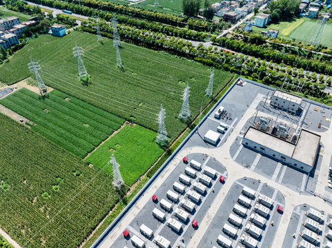 aerial view of energy storage power station next to green farmland