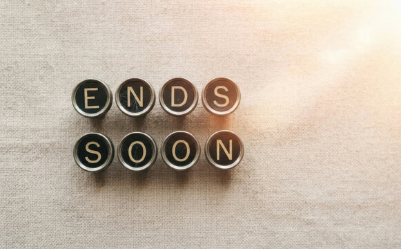 Ends Soon message spelled out with vintage typewriter keys on textured fabric background representing urgency and deadline concept