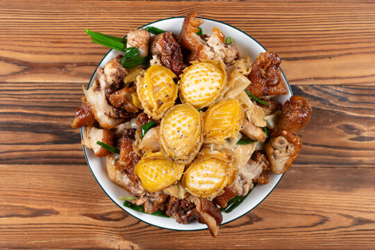 Home cooked dish of roasted pork with abalone served in white dish