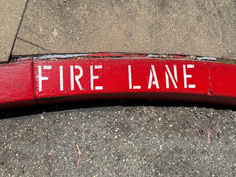 A bright red curb marked  FIRE LANE