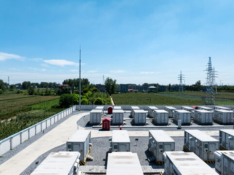 rows of outdoor energy storage battery containers under blue sky